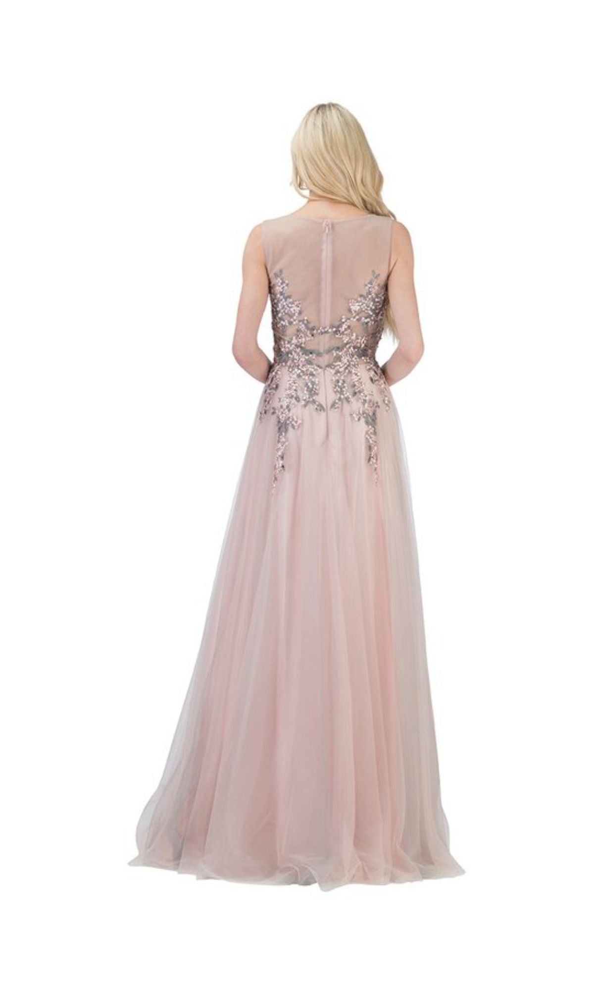 A woman with long blonde hair models the Chicas C7545 Blush Pink Long Prom Ball Gown, a sleeveless, floor-length A-line dress with floral embellished bodice and back, standing and facing away from the camera.